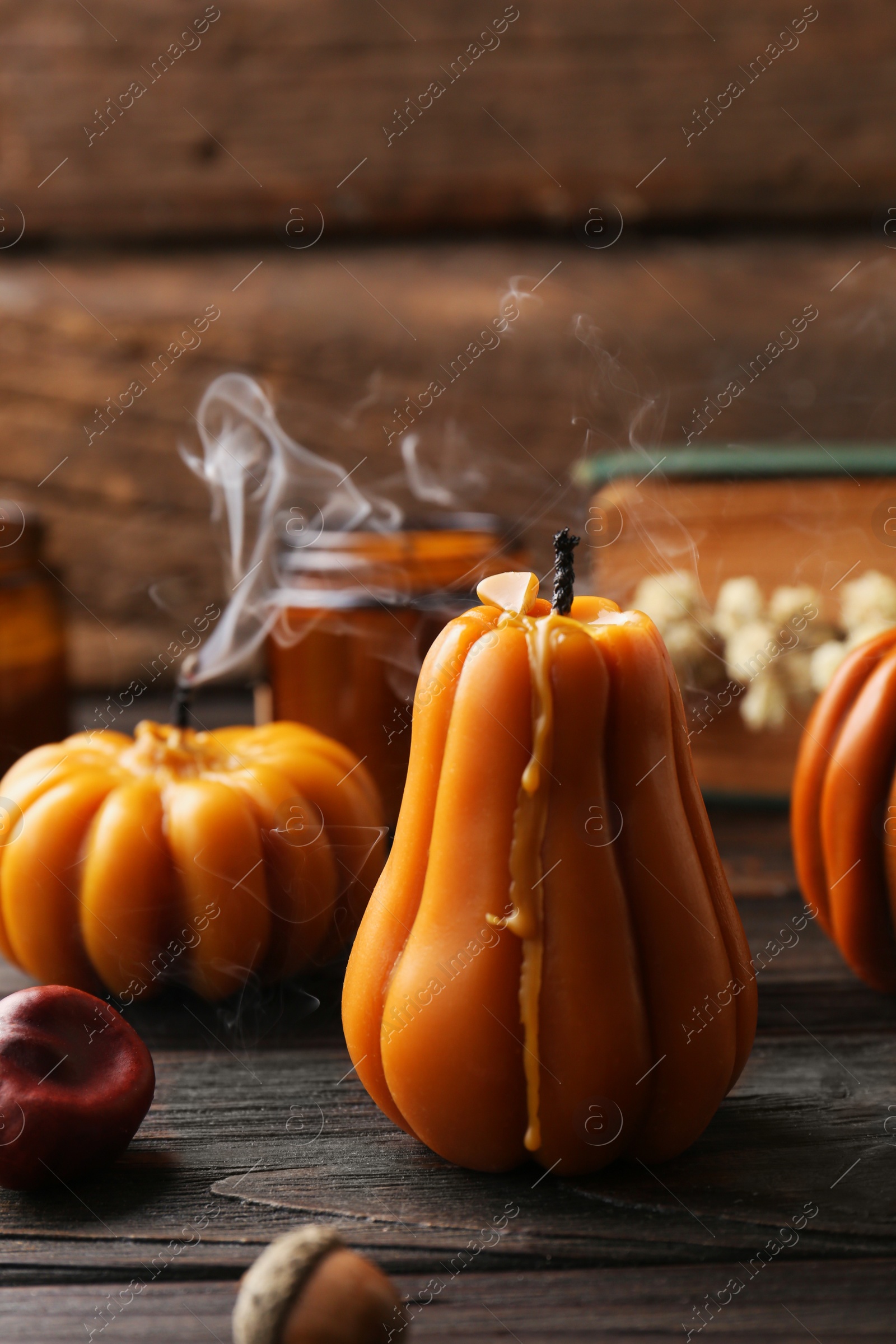 Photo of Blown out candles on wooden table. Autumn atmosphere