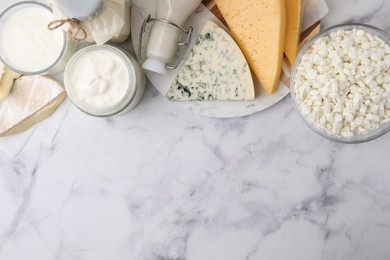 Photo of Different fresh dairy products on white marble table, top view. Space for text