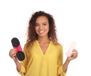 Photo of Young African American woman with reusable menstrual pad and pantyliner on white background
