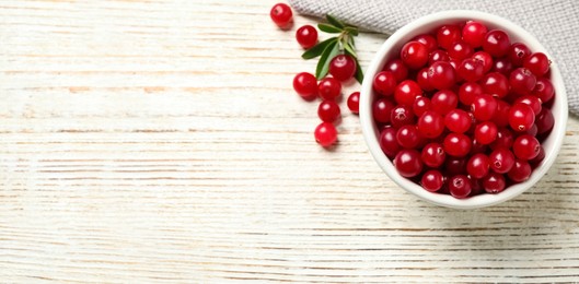 Image of Tasty ripe cranberries on white wooden table, top view. Banner design with space for text