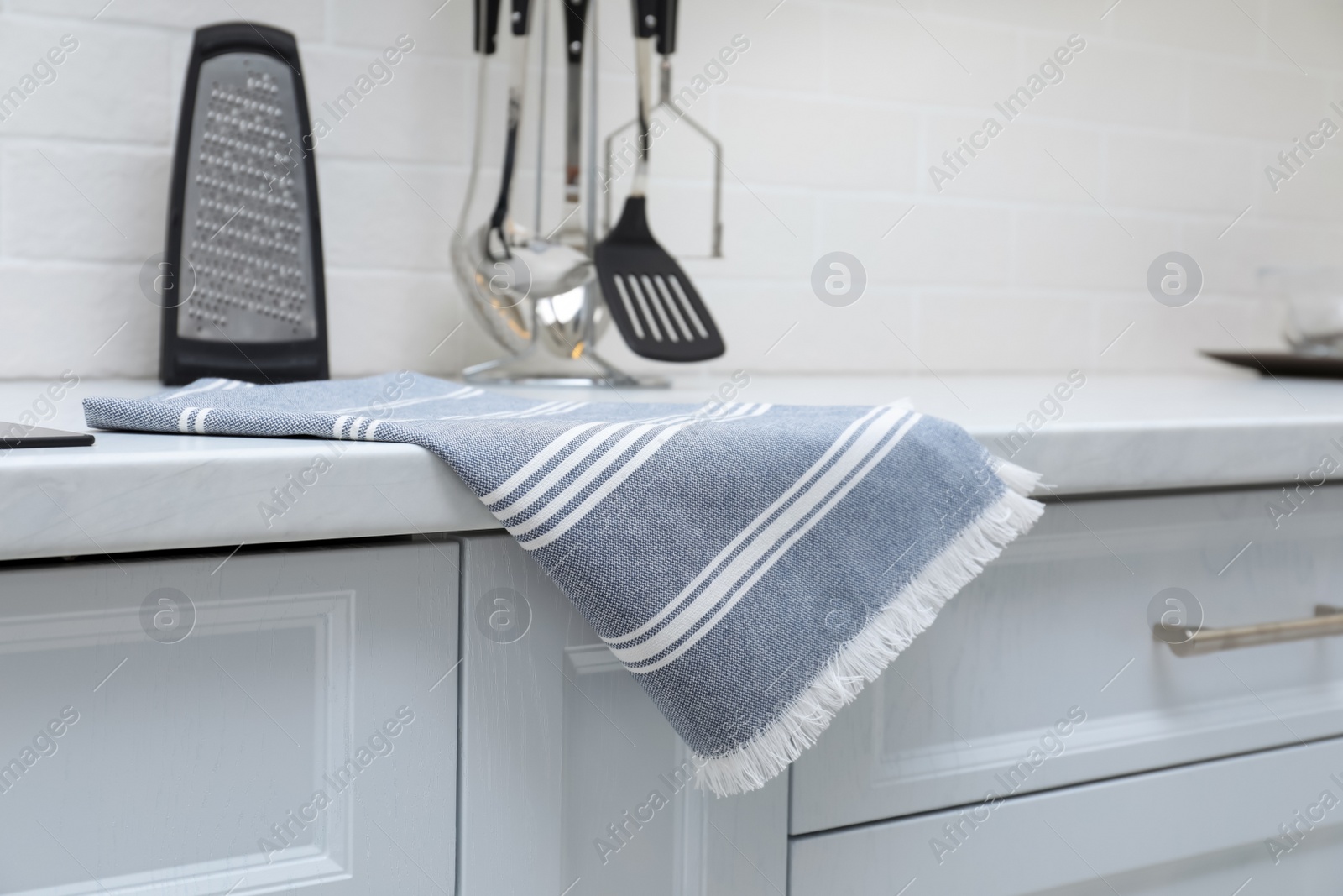 Photo of Clean kitchen towel on counter at home, closeup