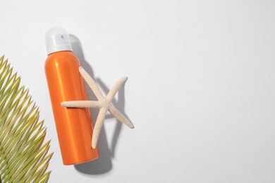 Sunscreen, starfish and tropical leaf on white background, flat lay and space for text. Sun protection care