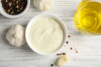 Photo of Flat lay composition with garlic sauce on white wooden background