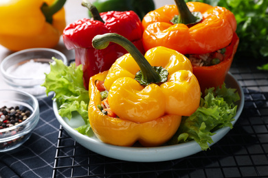 Photo of Tasty stuffed bell peppers on table, closeup