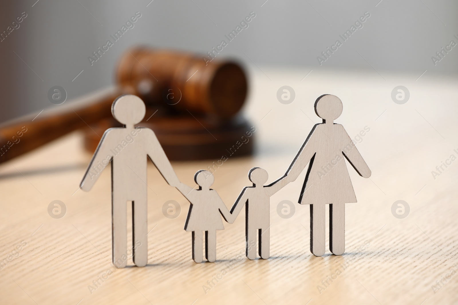 Photo of Family law. Figure of parents with children and gavel on wooden table