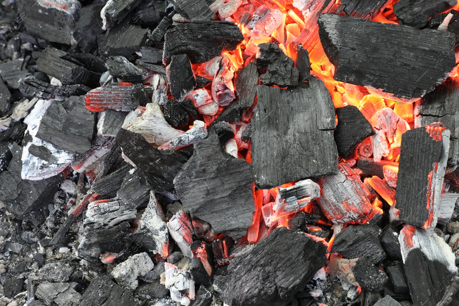 Photo of Many smoldering coals as background, top view