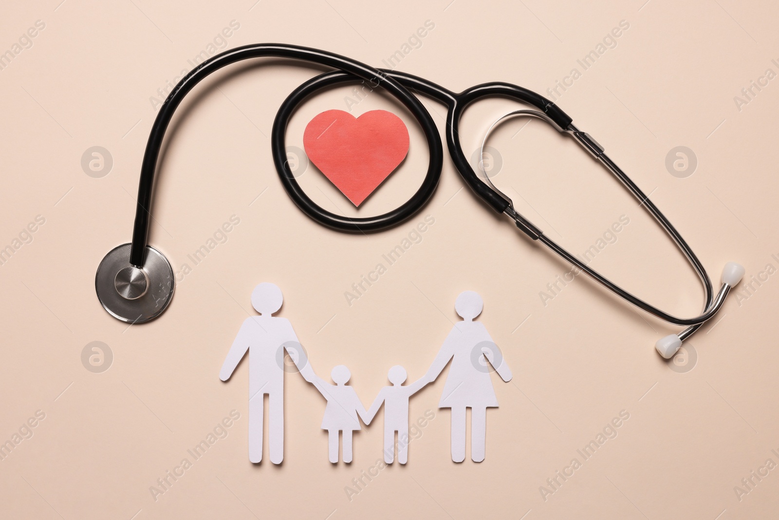 Photo of Paper family figures, red heart and stethoscope on beige background, flat lay. Insurance concept