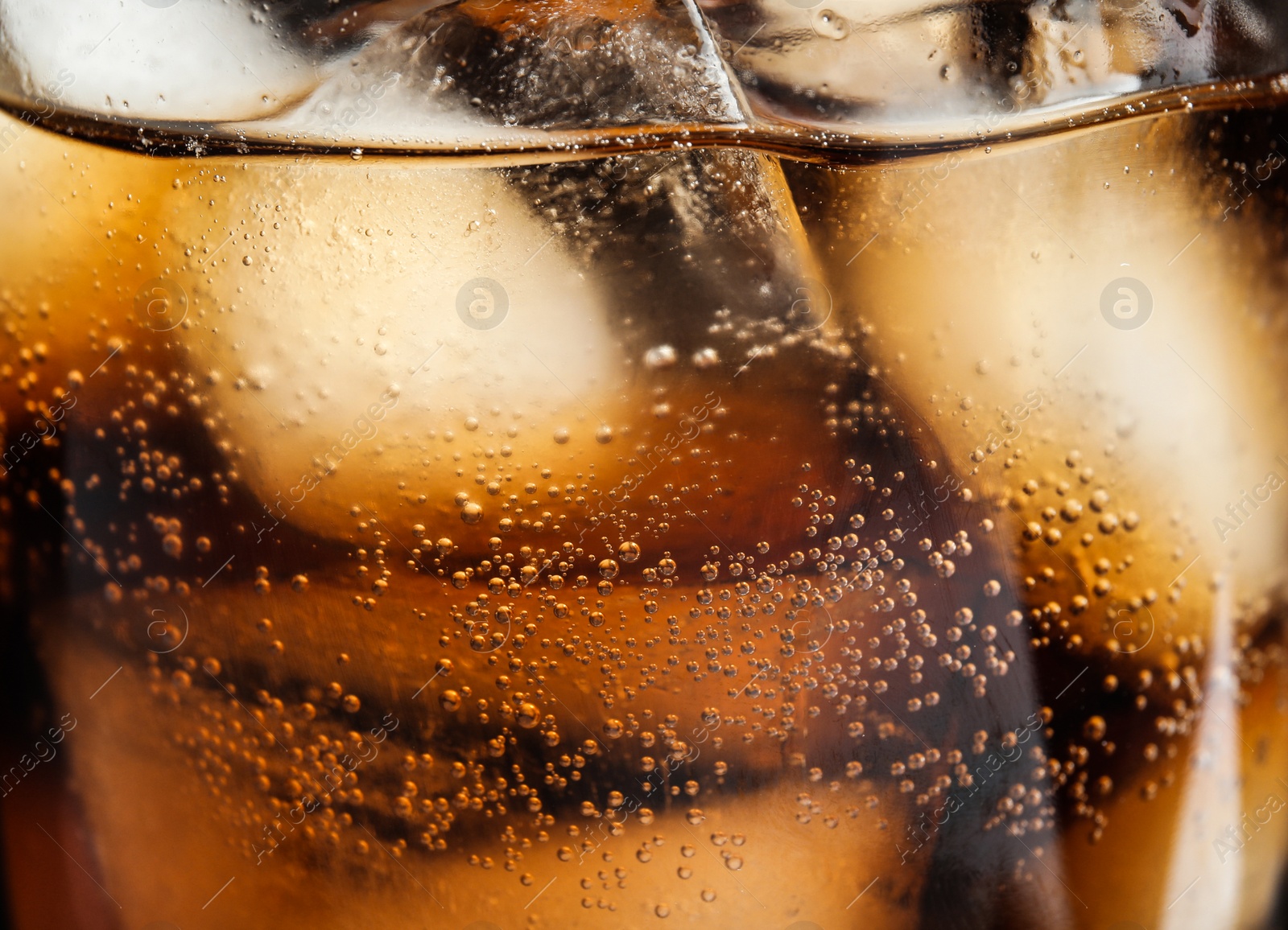 Photo of Glass of tasty refreshing cola with ice cubes on black background, closeup