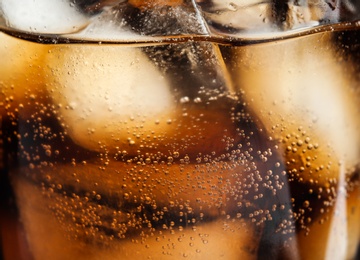 Glass of tasty refreshing cola with ice cubes on black background, closeup