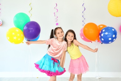 Photo of Adorable little girls at birthday party indoors