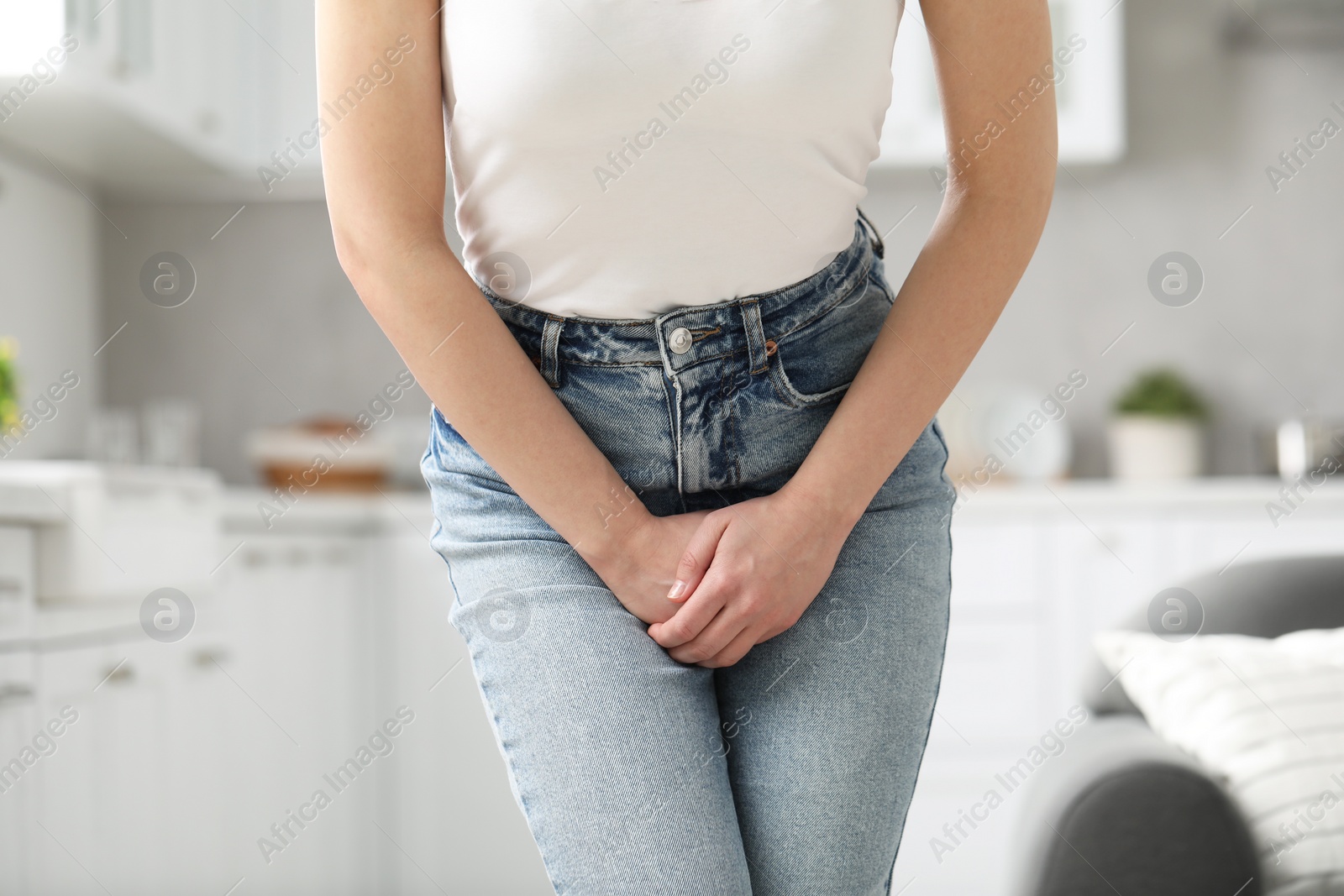 Photo of Woman suffering from cystitis at home, closeup