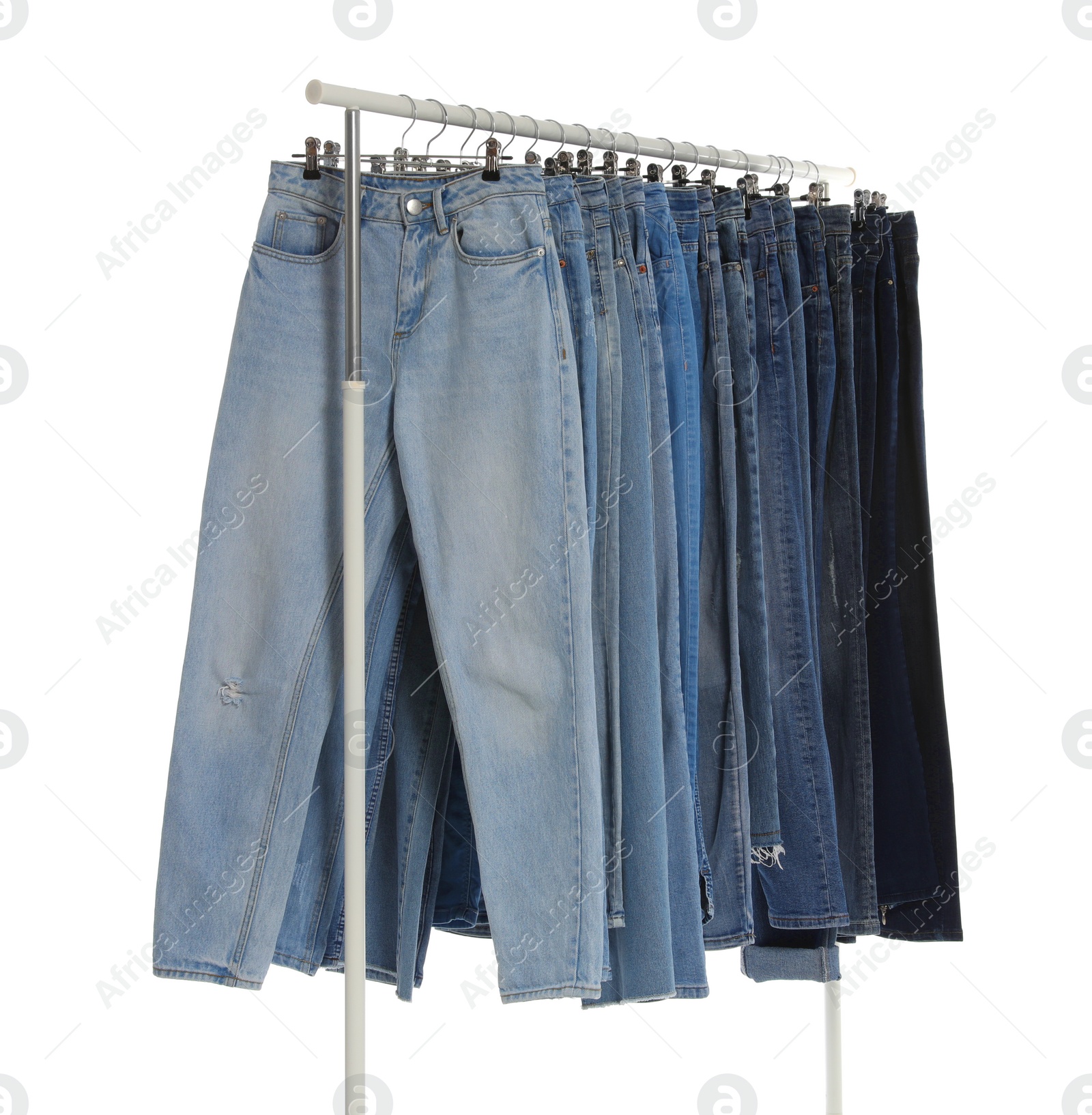 Photo of Rack with different jeans isolated on white