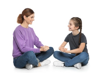 Hearing impaired mother and her child talking with help of sign language on white background