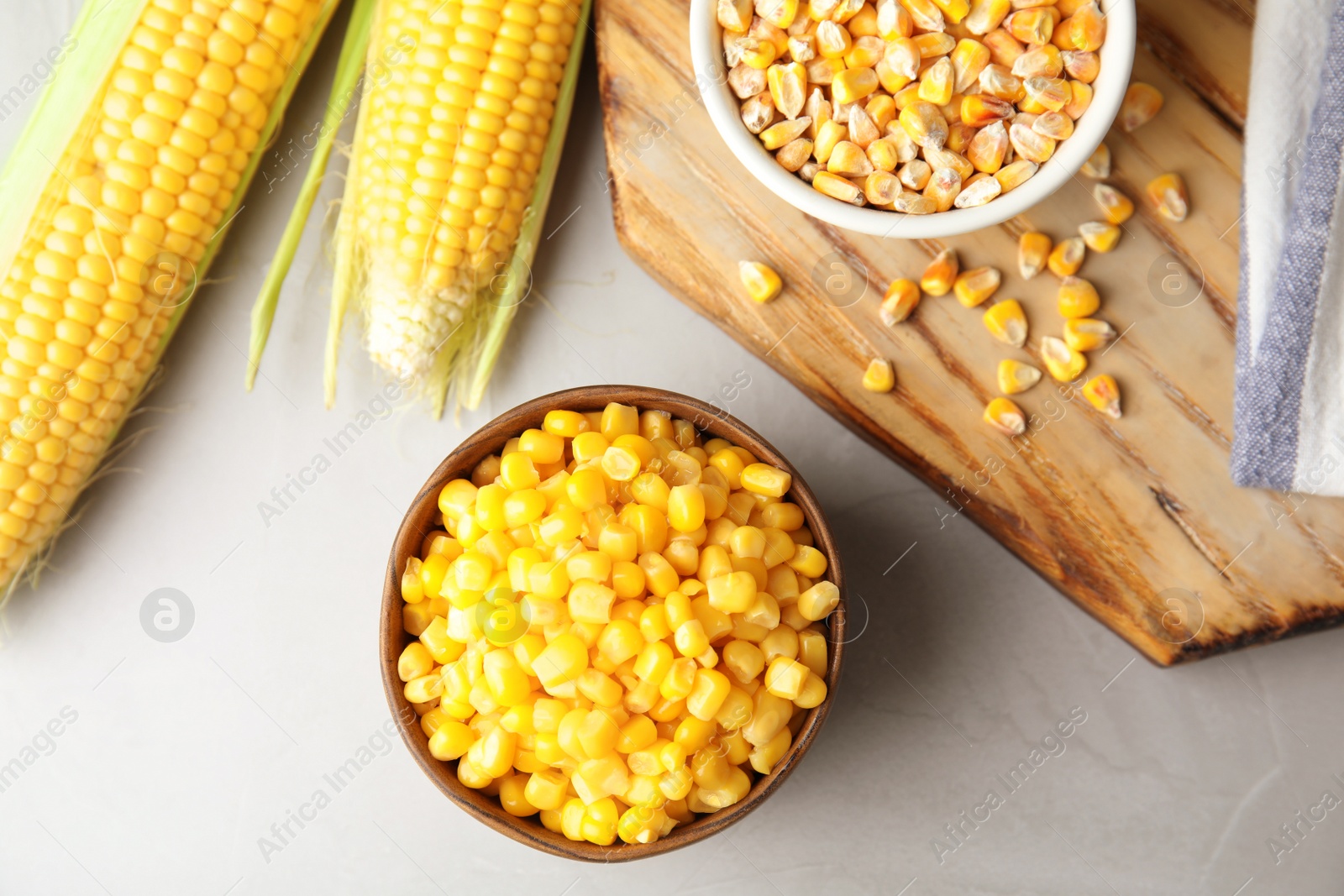 Photo of Flat lay composition with corn kernels on grey background