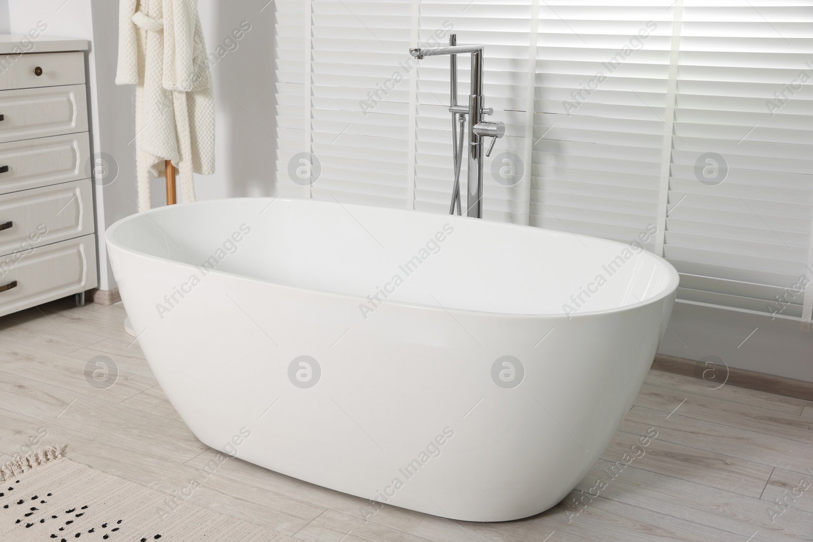 Photo of Stylish bathroom interior with white ceramic tub