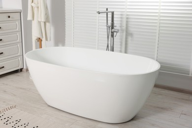 Stylish bathroom interior with white ceramic tub