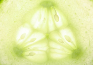 Photo of Slice of ripe cucumber as background, closeup