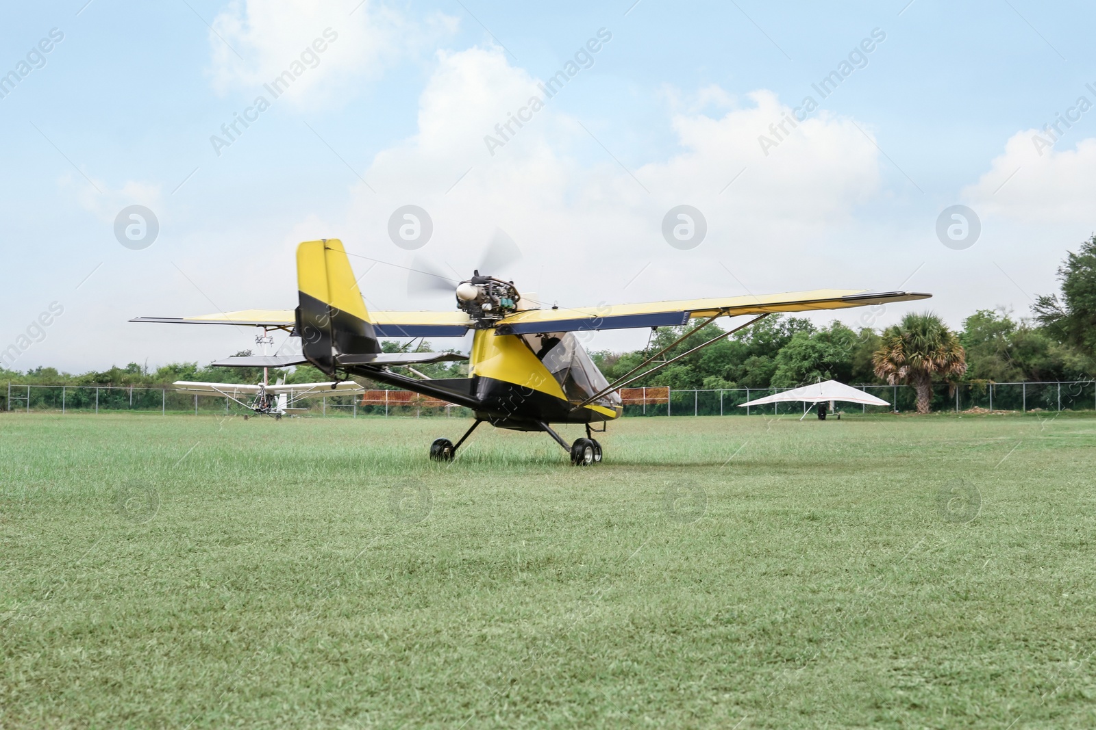 Photo of Modern light aircraft on green grass outdoors