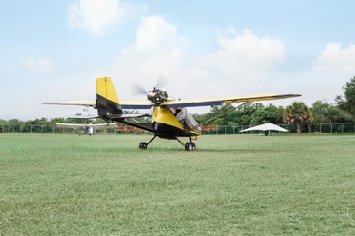 Modern light aircraft on green grass outdoors