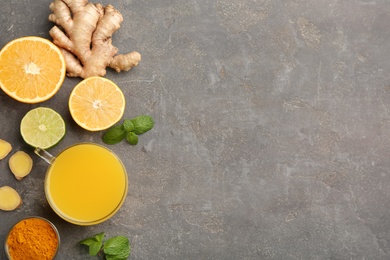 Flat lay composition with immunity boosting drink on grey table. Space for text