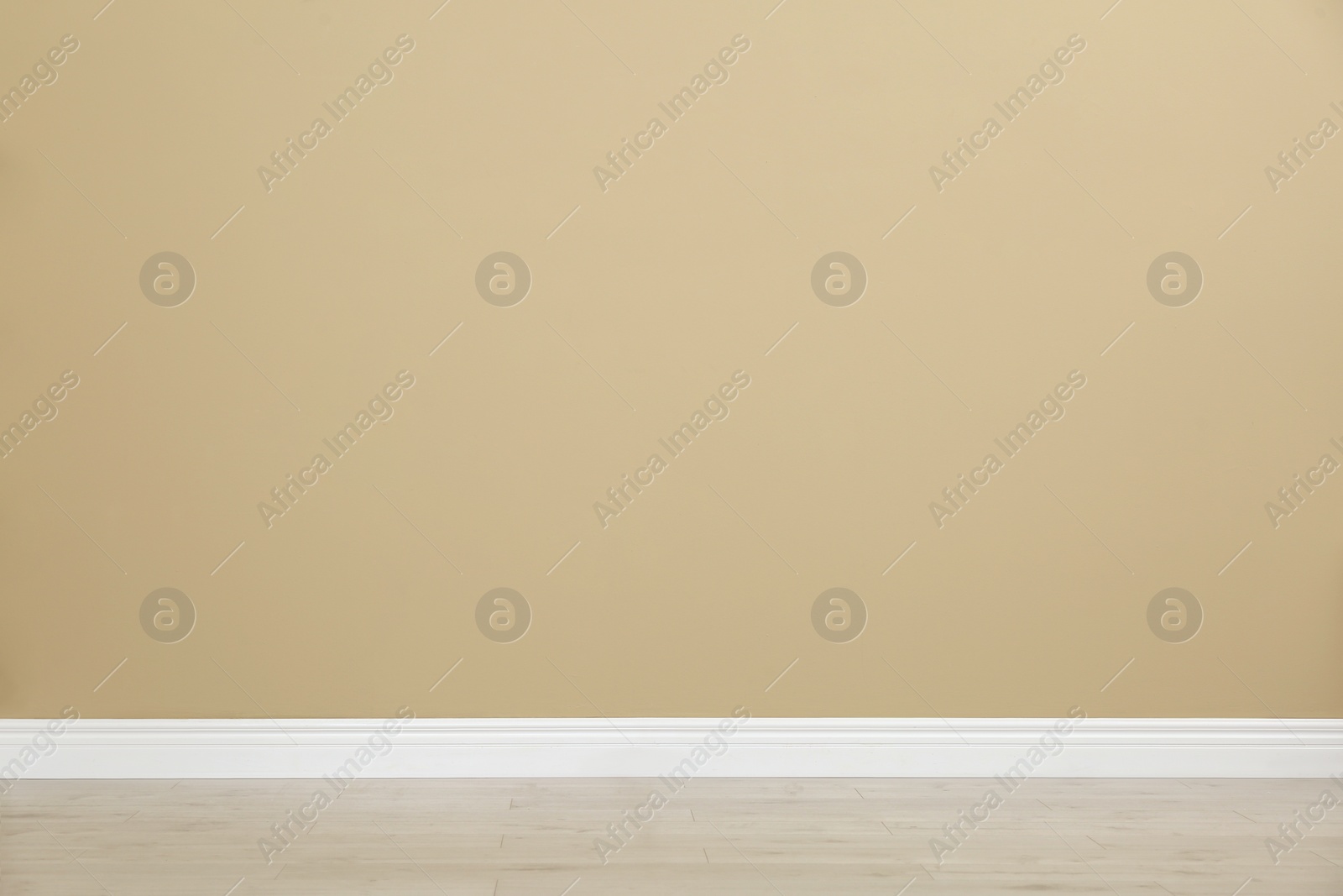 Photo of Empty room with beige wall and wooden floor