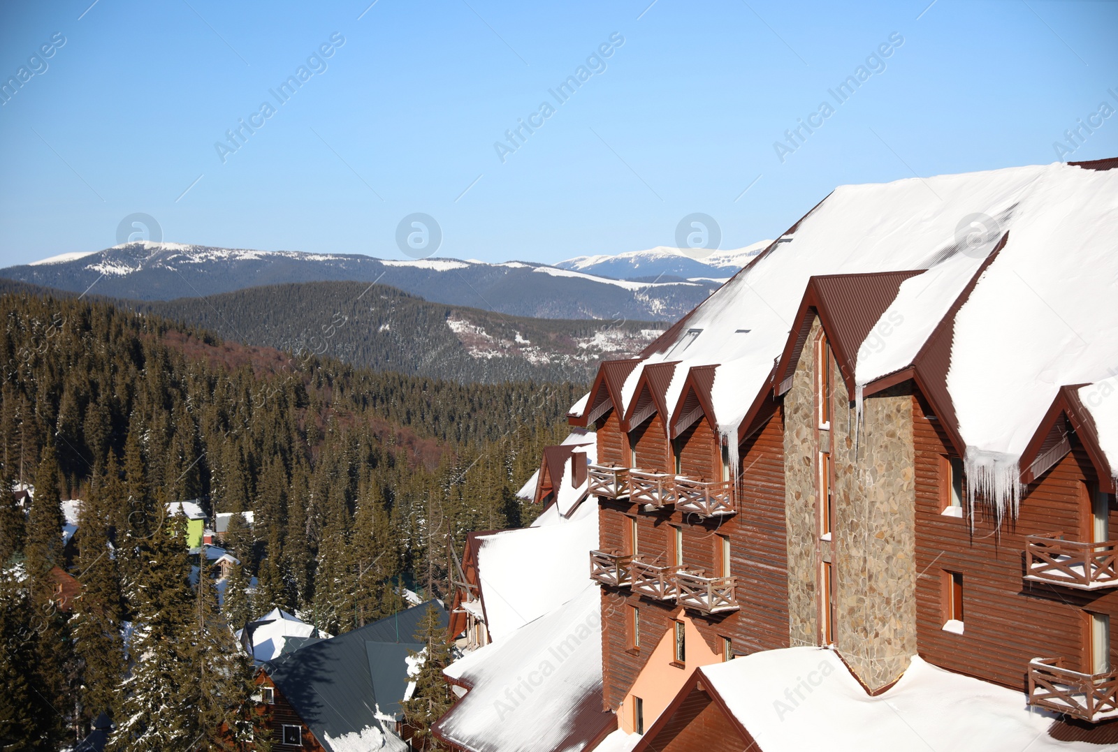 Photo of Wooden cottage covered with snow on winter day