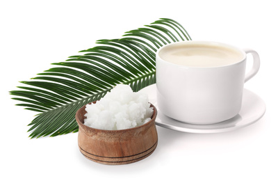 Photo of Delicious coffee with organic coconut oil and palm leaf isolated on white