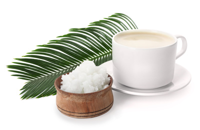 Delicious coffee with organic coconut oil and palm leaf isolated on white