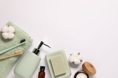 Photo of Bath accessories. Different personal care products and cotton flowers on white background, flat lay with space for text