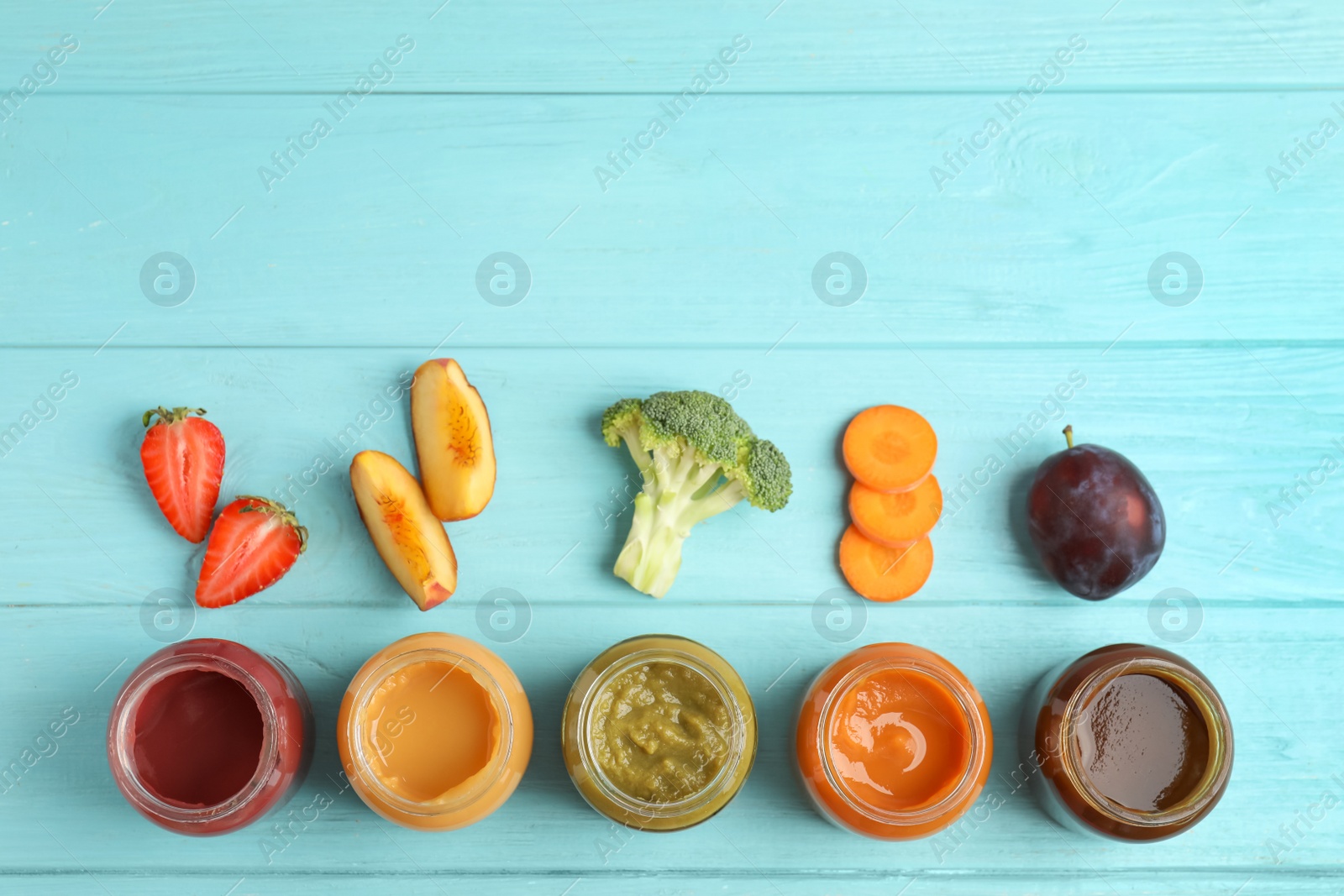 Photo of Flat lay composition with healthy baby food and ingredients on light blue wooden table. Space for text