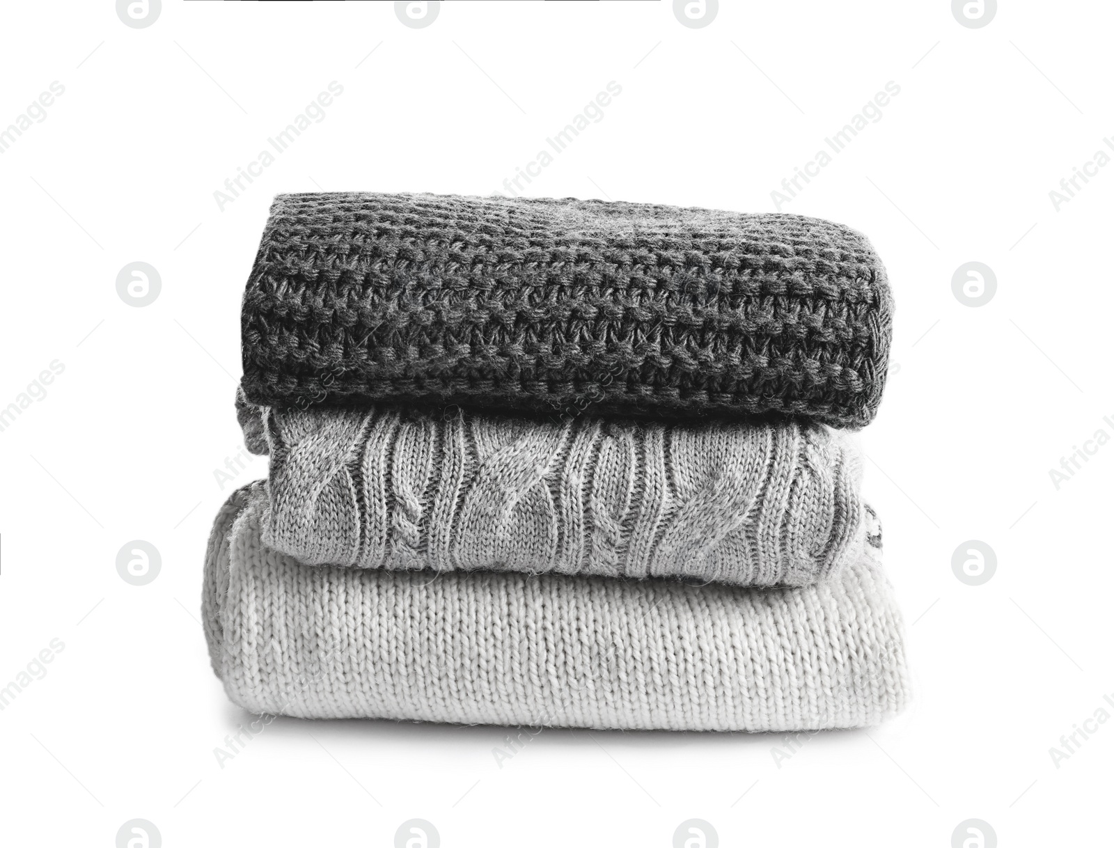 Photo of Stack of warm knitted clothes on white background