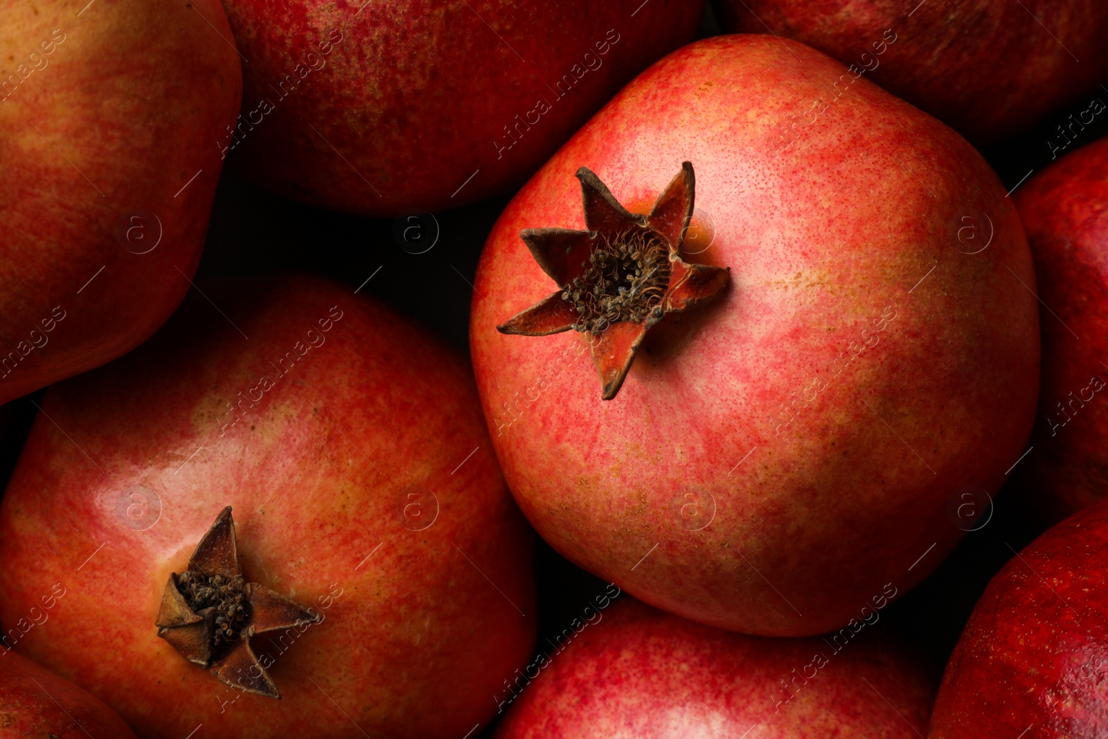 Photo of Fresh ripe pomegranates as background, top view