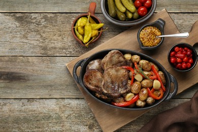 Photo of Tasty beef tongue pieces with potatoes served on wooden table, flat lay. Space for text