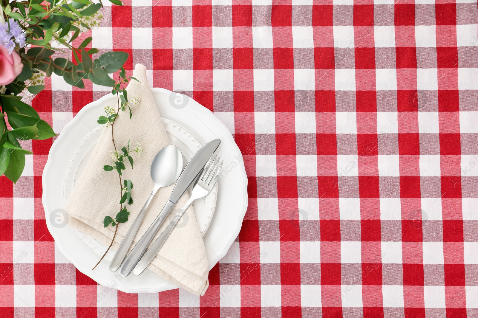 Photo of Stylish setting with cutlery, plates, napkin and floral decor on table, top view. Space for text