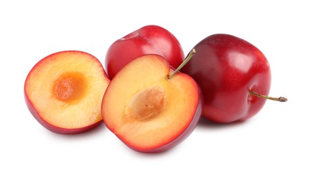 Photo of Cut and whole cherry plums on white background