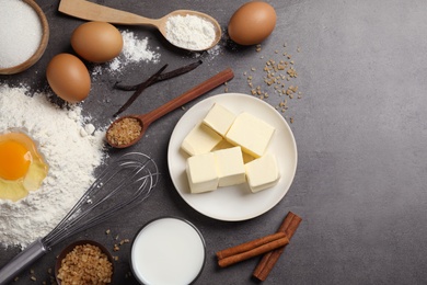 Photo of Flat lay composition with fresh ingredients for delicious homemade cake on grey table