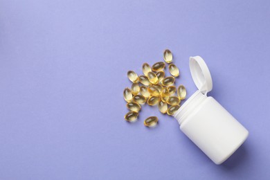 Photo of White bottle and vitamin capsules on violet background, top view. Space for text