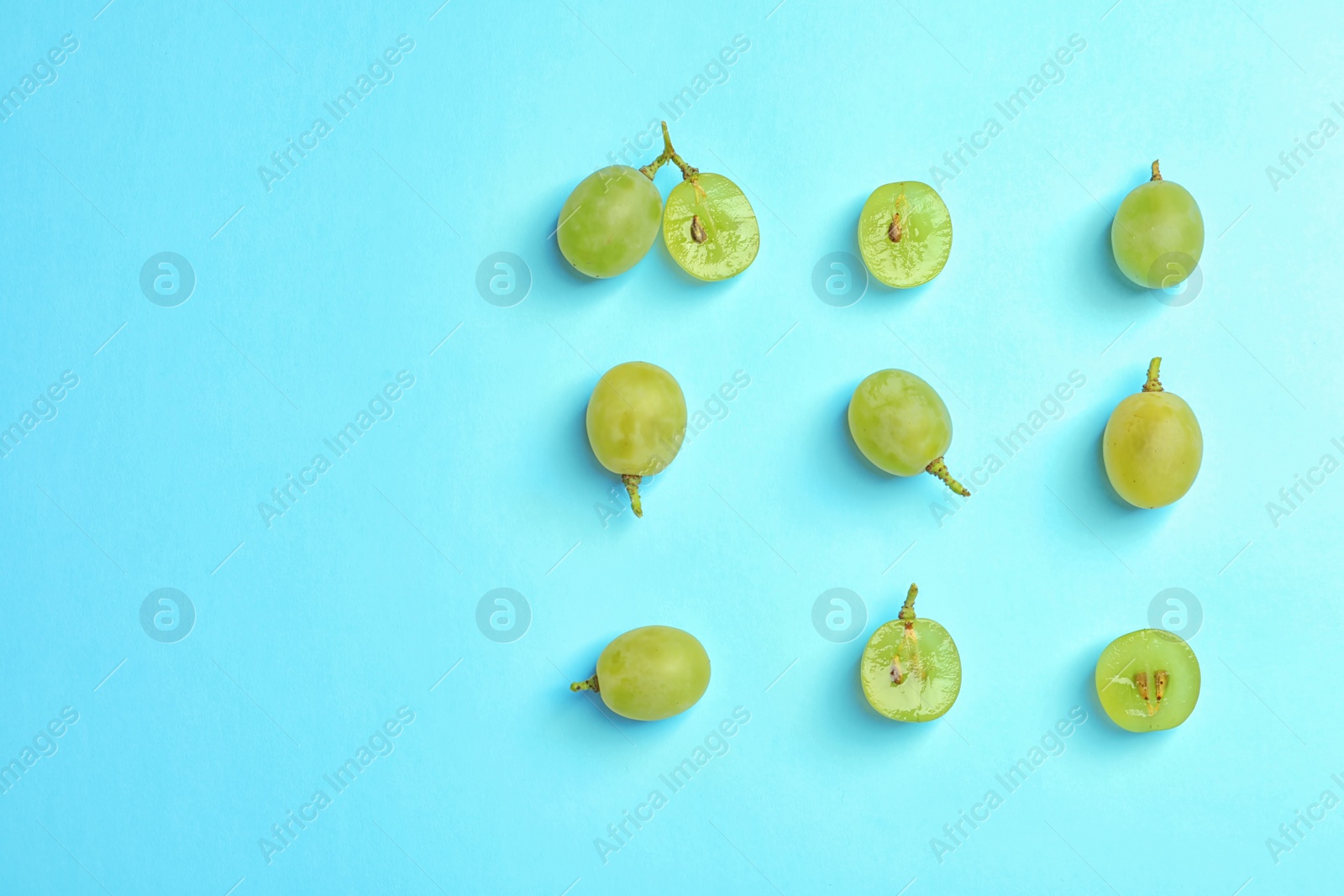 Photo of Fresh ripe juicy green grapes on color background, top view. Space for text