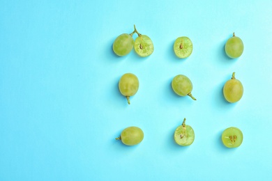 Fresh ripe juicy green grapes on color background, top view. Space for text