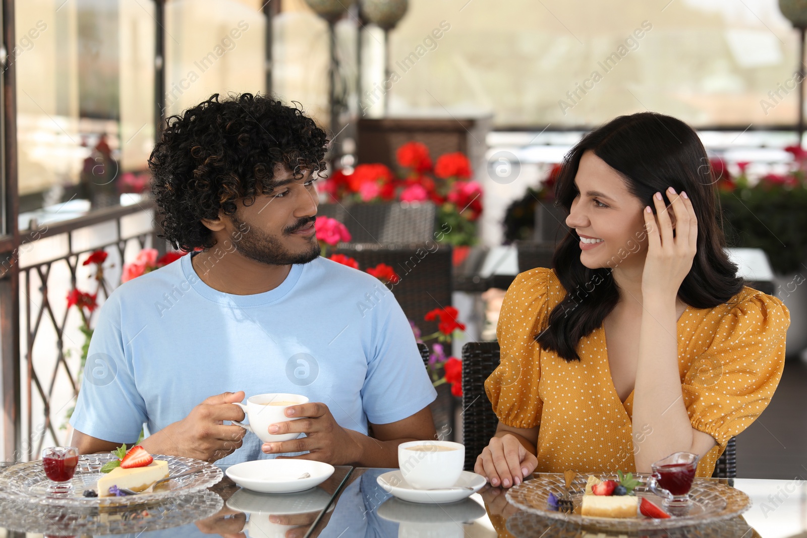 Photo of International dating. Happy couple spending time together in restaurant