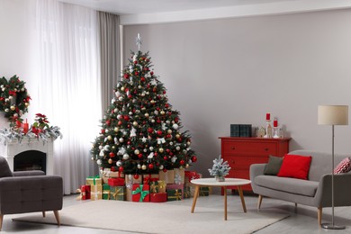 Beautiful Christmas tree and gifts near fireplace in festively decorated living room