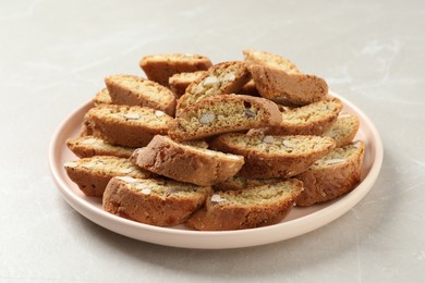 Photo of Traditional Italian almond biscuits (Cantucci) on light marble table