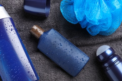 Photo of Flat lay composition with men's cosmetics on grey towel