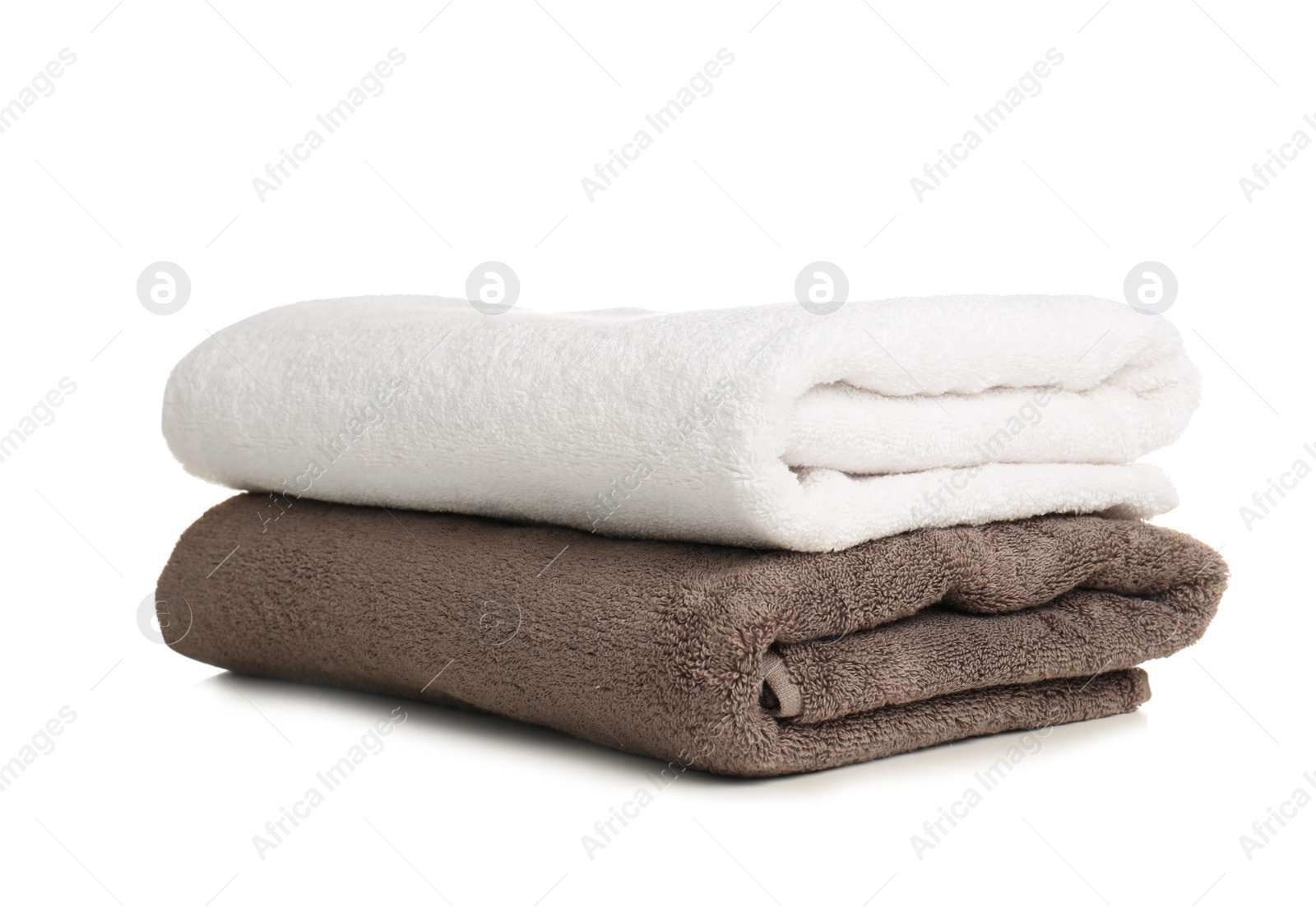 Photo of Folded soft terry towels on white background