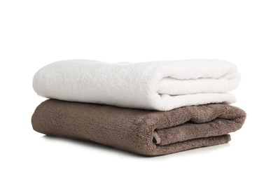 Photo of Folded soft terry towels on white background