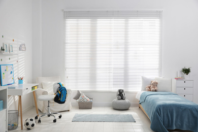 Photo of Modern child room interior with comfortable bed