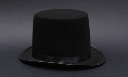 Photo of One magician top hat on dark grey background