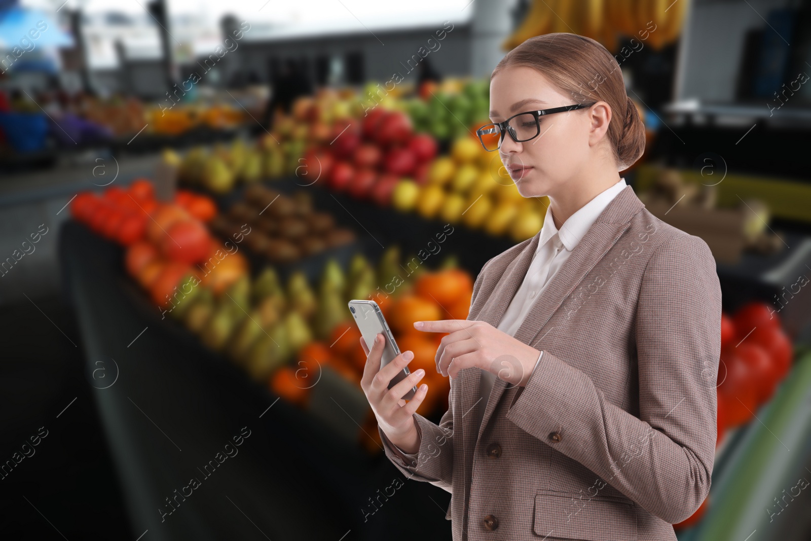 Image of Wholesale and logistics concept. Manager using phone at market
