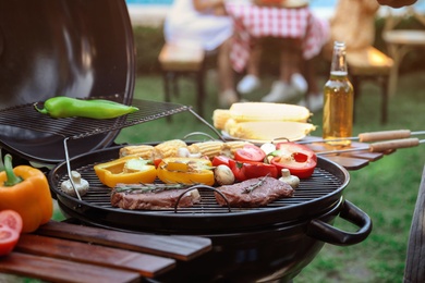 Barbecue grill with tasty fresh food outdoors