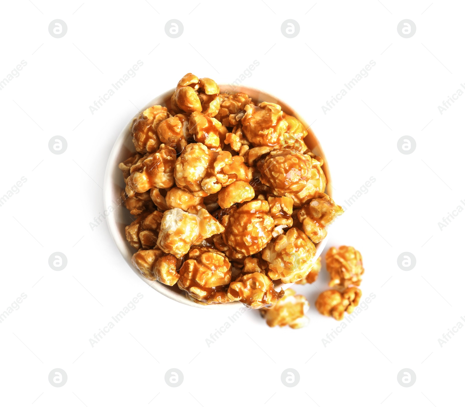 Photo of Delicious popcorn with caramel in paper bucket on white background